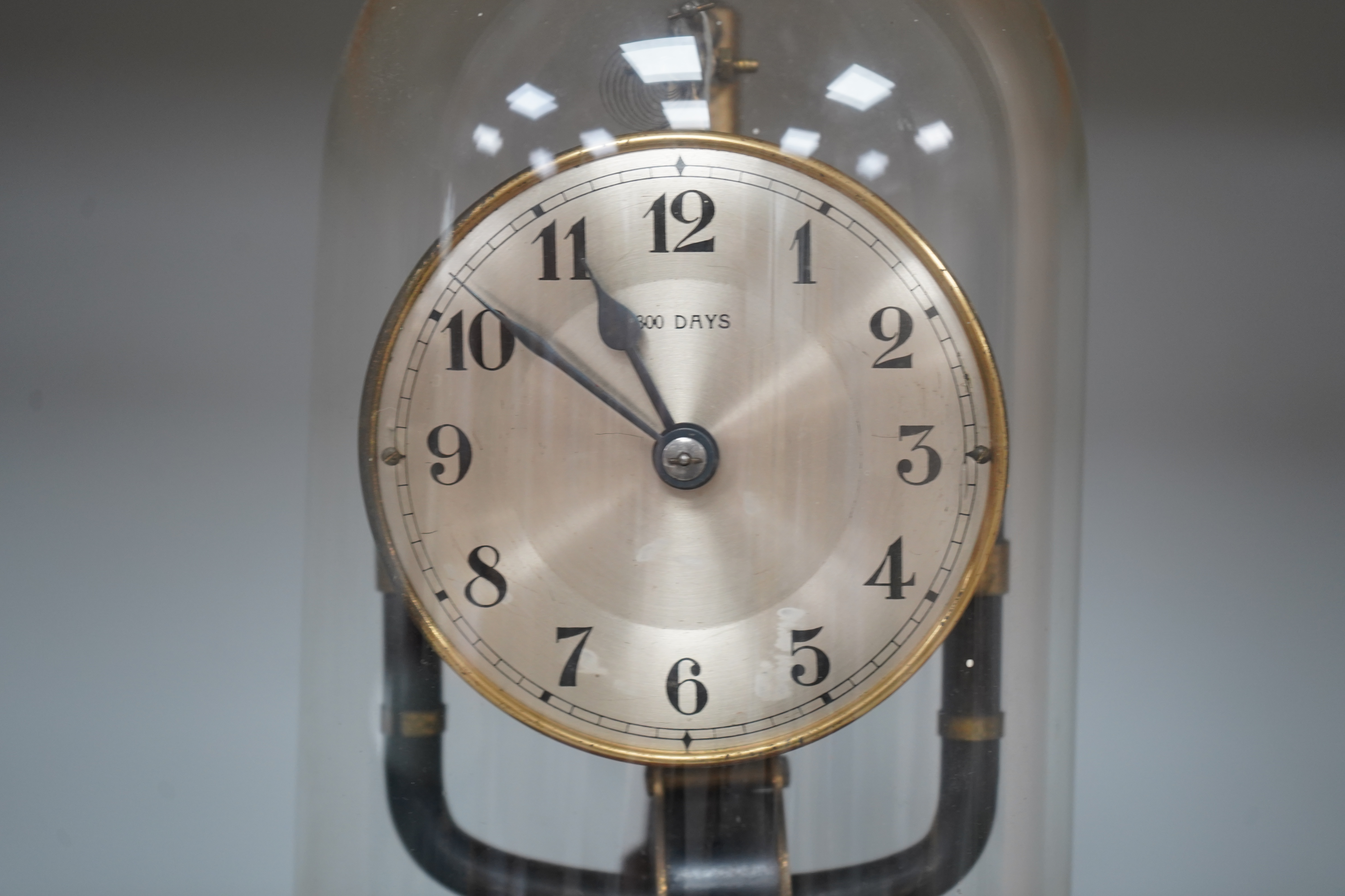 A Bulle type 800 day electric clock, under a glass dome, 26cm high. Condition - fair, untested